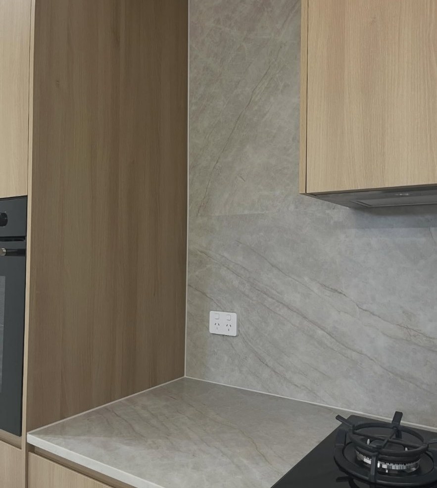 Close up of stone splashback and benchtop junction with a neat internal caulking finish