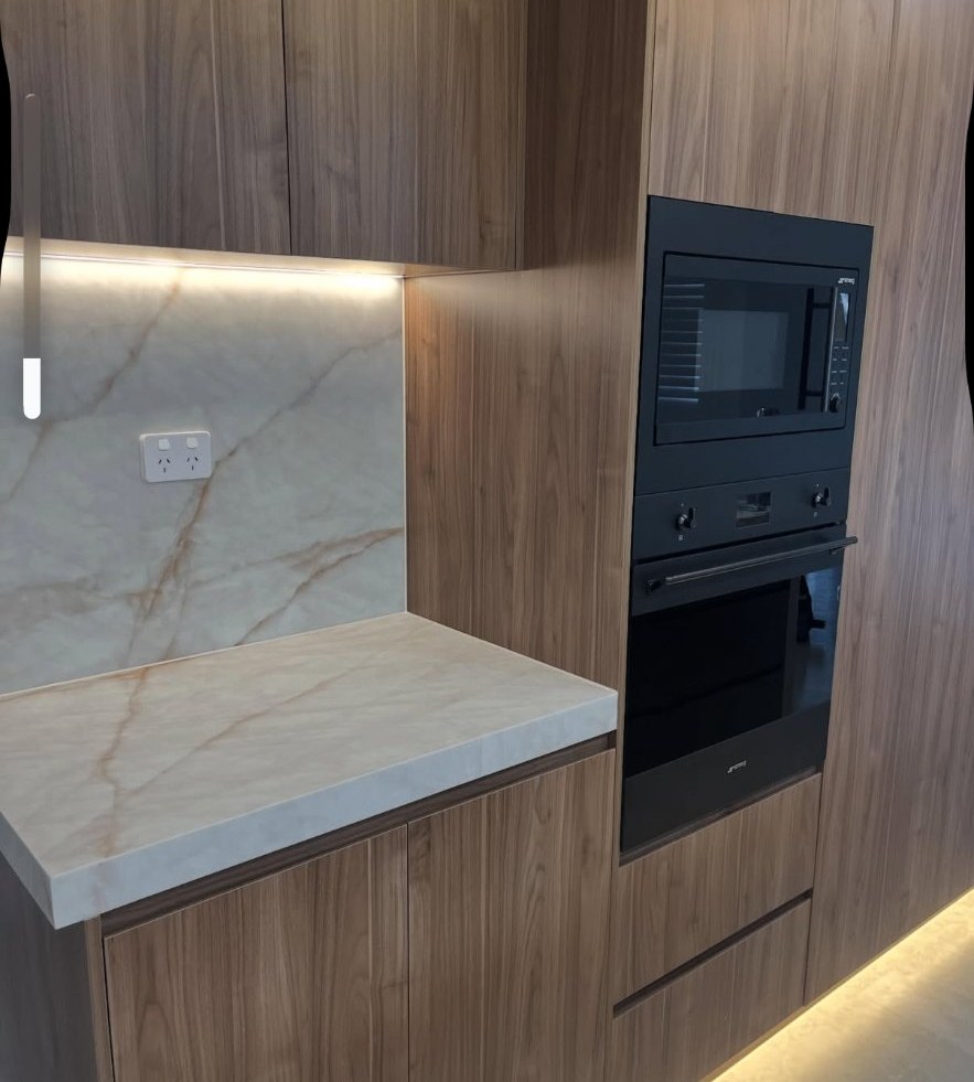 Timber kitchen with marble splashback and appliance tower, internal caulking completed in Cecil Hills