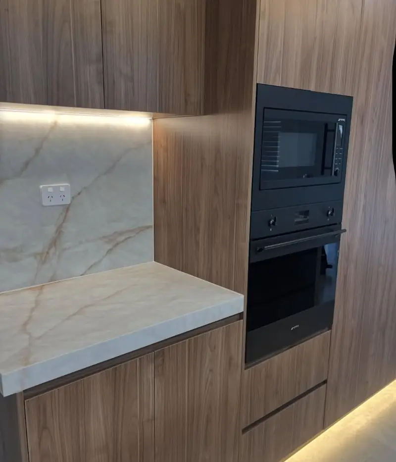 Timber kitchen with marble splashback and appliance tower, internal caulking completed in Cecil Hills