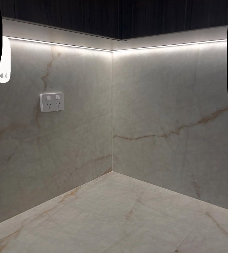 Marble tiled butler pantry corner with precise silicone seal along the wall and floor junction