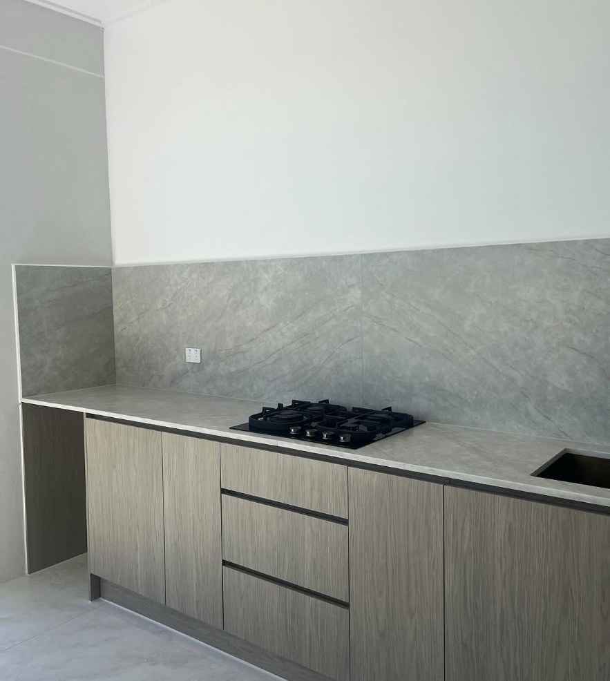 Timber kitchen with stone splashback in Austral, caulked with straight consistent silicone lines