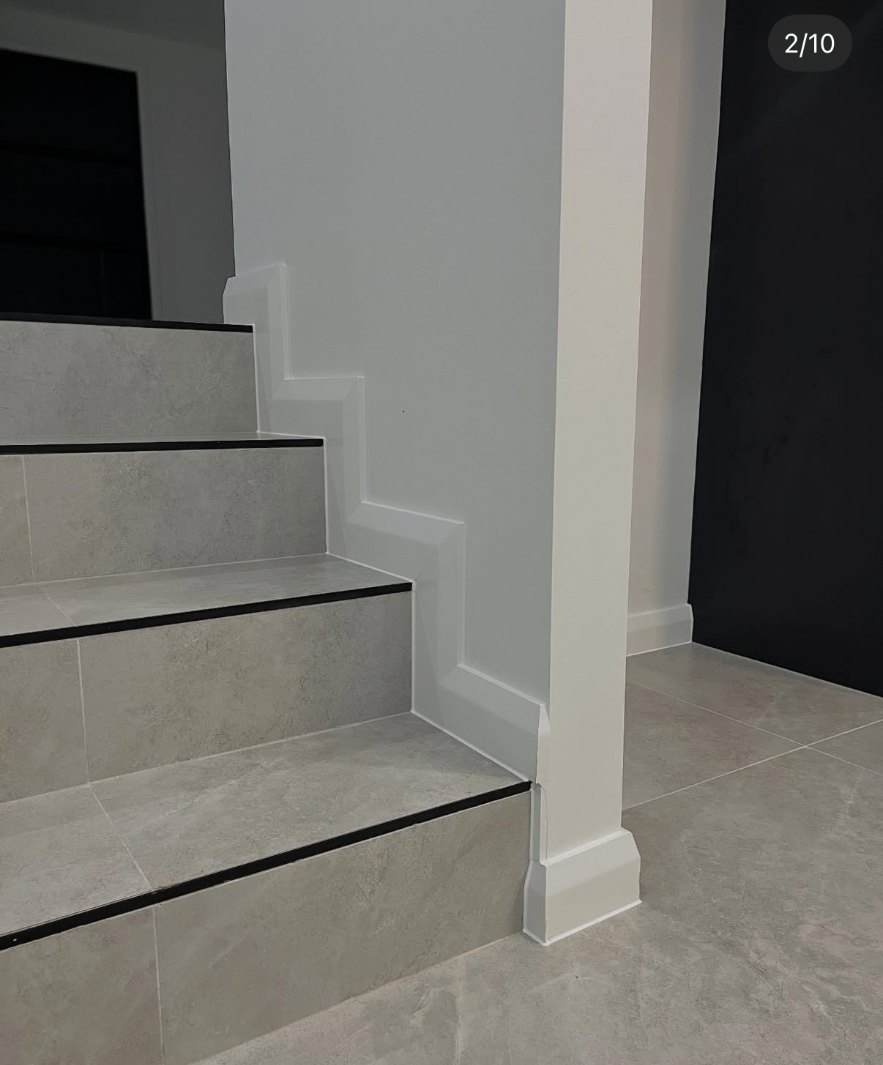 Tiled staircase and skirting detail with a straight, clean caulking line