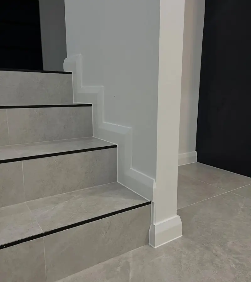 Tiled staircase and skirting detail with a straight, clean caulking line